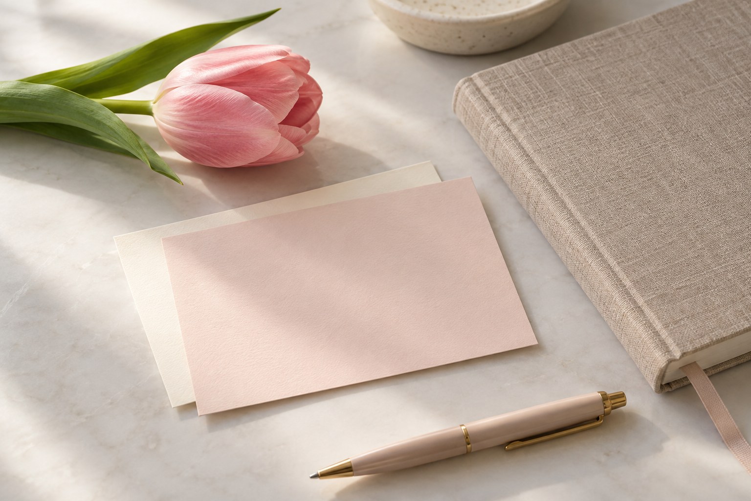 A journal, blank cards, and flowers ready for a handwritten note